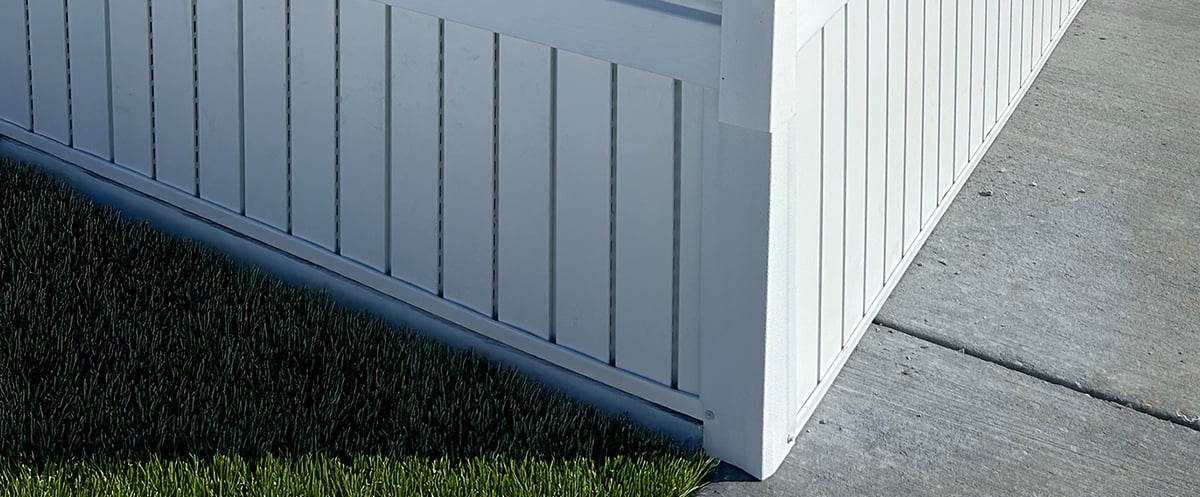 corner of a mobile home featuring white skirting 
